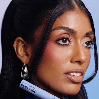 Woman holding a hair straightener with 'eyeCONIC' branding