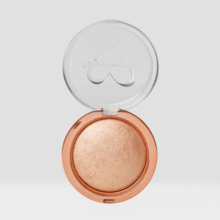Open compact of highlighter with visible brand logo on a light gray background. Shade is Champagne Kiss Shimmer Veil Beauty Creations Face and Body Highlighter