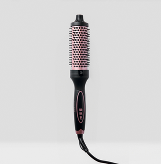 Black and pink hair styling tool on a light gray background