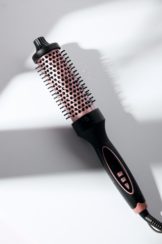 Black and pink hairbrush on a white background
