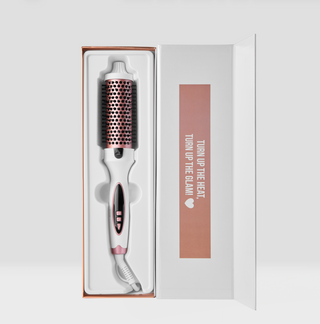 Hair styling tool in a box with 'Turn Up the Heat, Turn Up the Glam' text on a white background