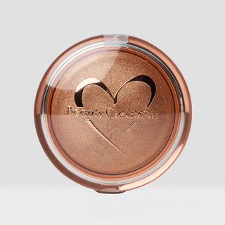 Bronze-colored makeup compact with 'Beauty Creations' logo on a light gray background Shade Color is Melted Gold. Face and Body Highlighter.