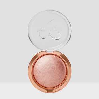 Open rose gold compact with a clear lid on a light gray background. Shade is Rose Glow Shimmer Veil Beauty Creations Face and Body Highlighter